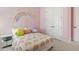 Cozy bedroom with cute rainbow themed decor and plushy decorations at 1737 Fence Post Rd, Wendell, NC 27591