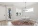 Charming breakfast nook features natural light, complemented by a stylish chandelier and cozy furnishings at 1737 Fence Post Rd, Wendell, NC 27591