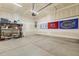 Spacious two-car garage with storage shelves and fan flags displayed at 1737 Fence Post Rd, Wendell, NC 27591