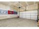 Spacious garage with ample room for parking and storage with flags on the wall at 1737 Fence Post Rd, Wendell, NC 27591