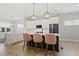 Spacious kitchen island with seating, black hardware, and contemporary pendant lighting at 1737 Fence Post Rd, Wendell, NC 27591