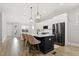 Bright kitchen features a large island, stainless steel appliances, and modern lighting at 1737 Fence Post Rd, Wendell, NC 27591
