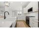 Bright, modern kitchen featuring an island with a farmhouse sink and stainless appliances at 1737 Fence Post Rd, Wendell, NC 27591