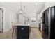 Open kitchen with large island, modern black appliances, and pendant lighting at 1737 Fence Post Rd, Wendell, NC 27591
