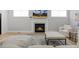 Bright living room with a modern fireplace and built-in shelving for additional storage at 1737 Fence Post Rd, Wendell, NC 27591