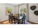 Bright dining room with modern decor, sleek dark wood furniture and views of lush green scenery at 176 Ethel Ln, Angier, NC 27501