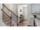 Inviting entryway showcasing a wooden staircase, console table, and view into the kitchen at 176 Ethel Ln, Angier, NC 27501