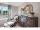 Comfortable sitting area featuring a padded chair and ottoman with a large window for natural light at 176 Ethel Ln, Angier, NC 27501