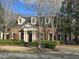 Traditional brick home featuring a columned front porch and manicured landscaping at 2000 Falls Farm Crossing Xing, Raleigh, NC 27614