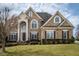 Stately brick home with arched windows and grand entrance, set on a well-manicured lawn at 2000 Falls Farm Crossing Xing, Raleigh, NC 27614