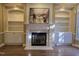Inviting living room features a fireplace, custom built-ins, and hardwood flooring at 2000 Falls Farm Crossing Xing, Raleigh, NC 27614