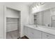Bathroom vanity with white countertop and walk-in closet at 209 Swift Park Dr, Zebulon, NC 27597