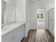 Bathroom with wood-look flooring, a glass enclosed shower and dual windows at 209 Swift Park Dr, Zebulon, NC 27597