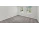 Cozy bedroom featuring carpeted floors, neutral paint, and great natural lighting at 209 Swift Park Dr, Zebulon, NC 27597