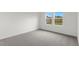Carpeted bedroom with a view of the backyard through double hung windows at 209 Swift Park Dr, Zebulon, NC 27597