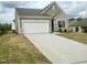Attractive exterior featuring a neutral color scheme, two-car garage, and concrete driveway at 209 Swift Park Dr, Zebulon, NC 27597