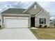 Charming one-story home with brick and vinyl siding, a two-car garage, and a well-manicured lawn at 209 Swift Park Dr, Zebulon, NC 27597