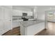 New kitchen with a large island, granite countertops, stainless steel appliances, and lots of natural light at 209 Swift Park Dr, Zebulon, NC 27597