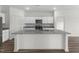 Bright kitchen featuring white cabinets, a granite countertop island, and modern appliances at 209 Swift Park Dr, Zebulon, NC 27597