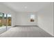 Well lit living room featuring carpeted floors and access to the patio through sliding glass doors at 209 Swift Park Dr, Zebulon, NC 27597