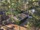 Aerial view of a charming home surrounded by lush trees, highlighting its serene setting and privacy at 2201 Knollwood Dr, Sanford, NC 27330