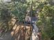 Aerial view of house nestled among lush trees, showcasing privacy and natural surroundings in a serene landscape at 2201 Knollwood Dr, Sanford, NC 27330