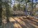 Aerial of a charming brick home nestled among mature trees on a spacious lot at 2201 Knollwood Dr, Sanford, NC 27330