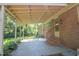 Covered patio with stairs, and a brick exterior that overlooks a lush backyard at 2201 Knollwood Dr, Sanford, NC 27330