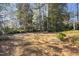 Spacious backyard with lush trees, shrubs and an opportunity for gardening projects at 2201 Knollwood Dr, Sanford, NC 27330