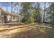 Spacious backyard with mature trees and covered patio, ideal for outdoor relaxation and entertaining at 2201 Knollwood Dr, Sanford, NC 27330