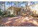 Brick patio leads to a covered porch, offering a charming outdoor space for relaxation and entertainment at 2201 Knollwood Dr, Sanford, NC 27330