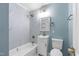 Contemporary bathroom featuring a modern sink, toilet, and tiled bathtub for luxurious living at 2201 Knollwood Dr, Sanford, NC 27330
