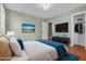 Modern bedroom with mounted television and large window providing ample lighting and modern design elements at 2201 Knollwood Dr, Sanford, NC 27330