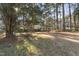 The property is surrounded by mature trees and has a sprawling lawn at 2201 Knollwood Dr, Sanford, NC 27330