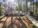 Classic brick home with a lush yard, complemented by mature trees and a long driveway at 2201 Knollwood Dr, Sanford, NC 27330
