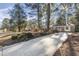 The property is surrounded by mature trees and a long driveway at 2201 Knollwood Dr, Sanford, NC 27330