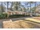 View of a charming single-story home with a brick facade and lush landscaping at 2201 Knollwood Dr, Sanford, NC 27330