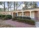 Charming brick home featuring a welcoming walkway, manicured bushes and a cozy covered front porch at 2201 Knollwood Dr, Sanford, NC 27330
