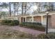 Charming brick home featuring a welcoming walkway, manicured bushes and a cozy covered front porch at 2201 Knollwood Dr, Sanford, NC 27330
