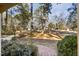A brick path leads through the landscaped front yard, showcasing the lush surroundings at 2201 Knollwood Dr, Sanford, NC 27330