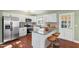 Stylish kitchen with white cabinetry, granite countertops, stainless steel appliances, and bar stool seating at 2201 Knollwood Dr, Sanford, NC 27330