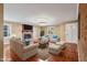 Spacious living room features a cozy brick fireplace and hardwood flooring, offering a comfortable space at 2201 Knollwood Dr, Sanford, NC 27330