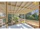 Covered porch with a view of the backyard, offering shade and a peaceful spot to enjoy the outdoors at 2201 Knollwood Dr, Sanford, NC 27330