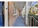 The side porch has traditional brick and white decorative railings at 2201 Knollwood Dr, Sanford, NC 27330