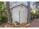 Charming storage shed with an open door, nestled amongst trees, perfect for storing outdoor equipment at 2201 Knollwood Dr, Sanford, NC 27330
