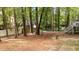 Wide backyard featuring grass, trees, and stairs leading to the house at 2301 Pastille Ln, Raleigh, NC 27612