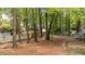 Spacious backyard features mature trees, landscaping, and fencing offering privacy and a natural setting at 2301 Pastille Ln, Raleigh, NC 27612