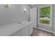Bathroom with a white vanity, wood-look vinyl flooring, and a well-lit interior at 2301 Pastille Ln, Raleigh, NC 27612
