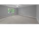 Spacious bedroom with neutral carpet and walls, and a view of the outdoors at 2301 Pastille Ln, Raleigh, NC 27612