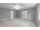 Spacious bedroom featuring neutral carpet and paint, ceiling fan and abundant natural light at 2301 Pastille Ln, Raleigh, NC 27612